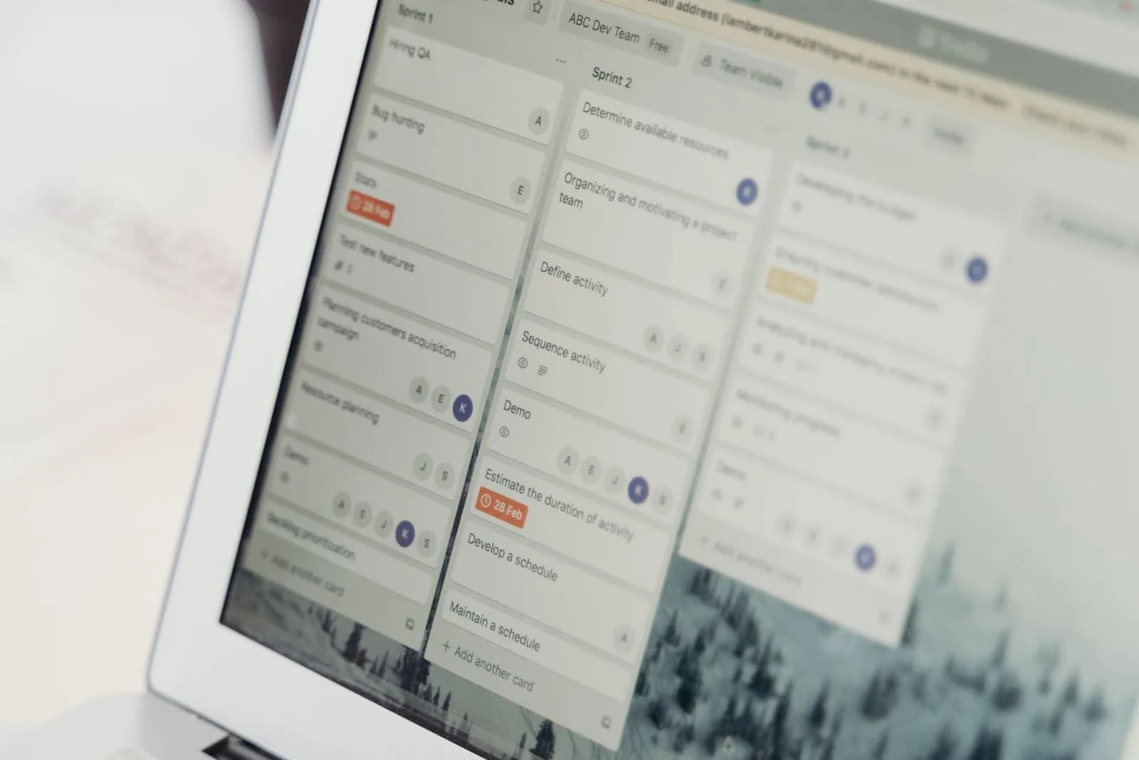 A task management board with workflow columns on a laptop screen