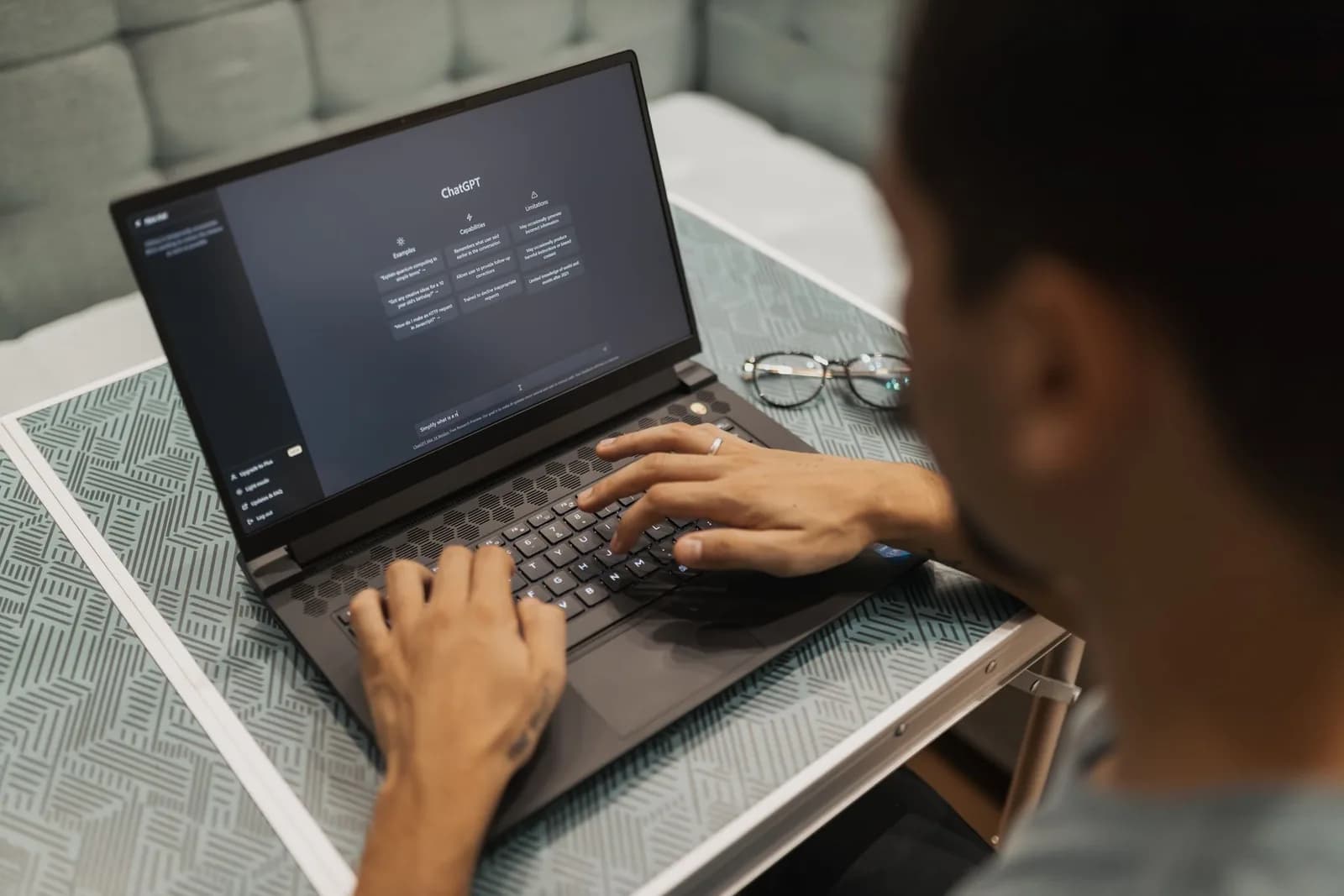 A person using ChatGPT on a laptop