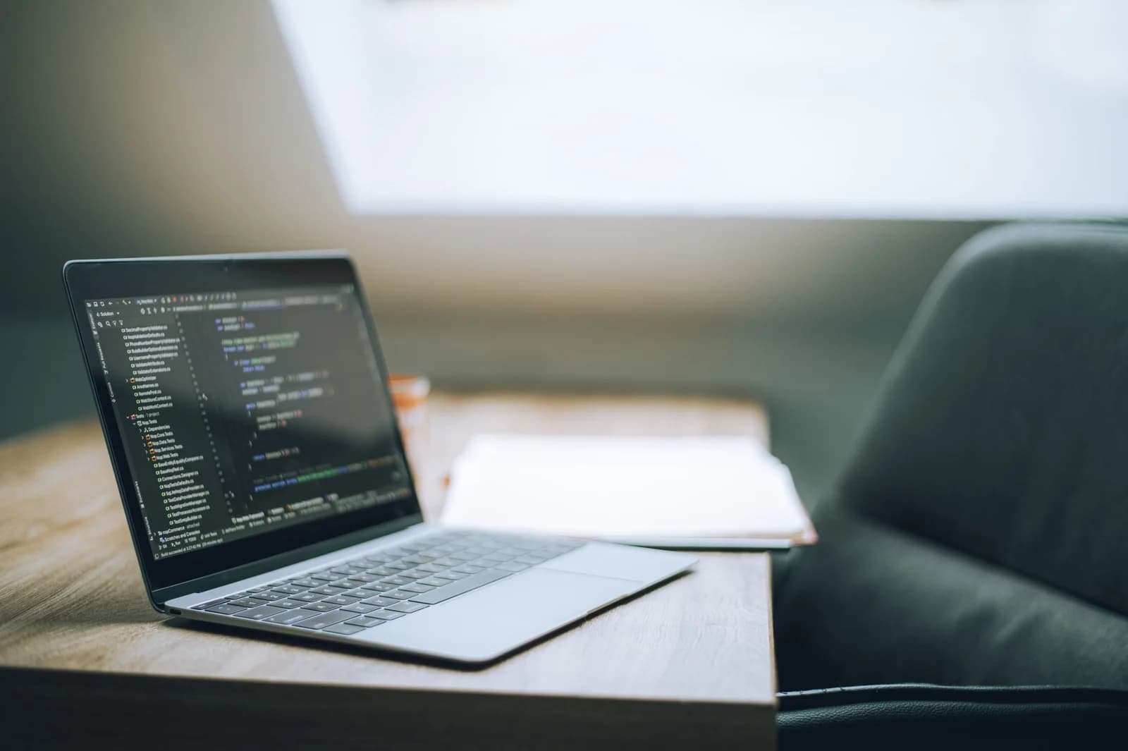 A software development workspace with code on a laptop